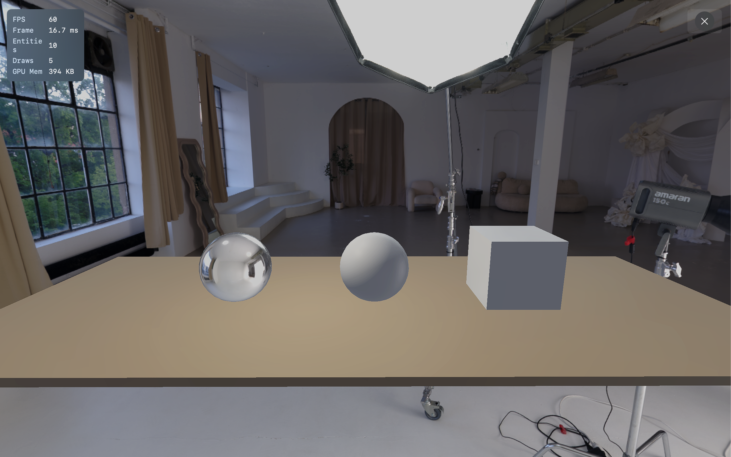 Default Hearth scene: wooden tabletop, unit cube, matte sphere, orbiting point light, directional sun, lit by the bundled 8k studio HDR.